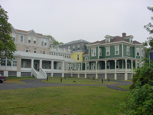 multicolored two storied house with white trim and columns