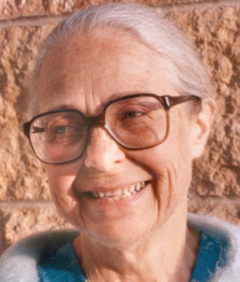 Close-up photo of Ade Bethune smiling.
